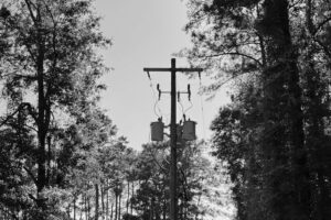 Utility pole with transformers and power lines