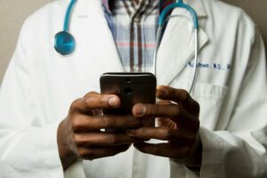Doctor using a mobile device in a clinic