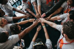 Volunteers with hands joined together